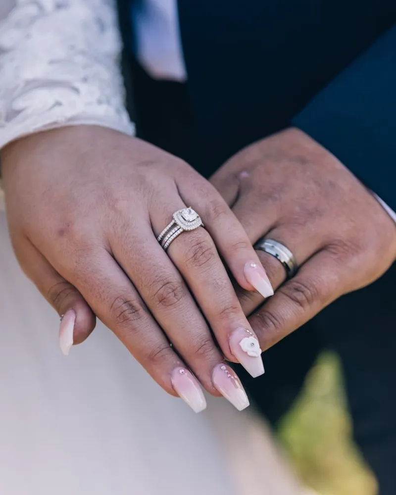 Bride's hands with a natural manicure and diamond ring