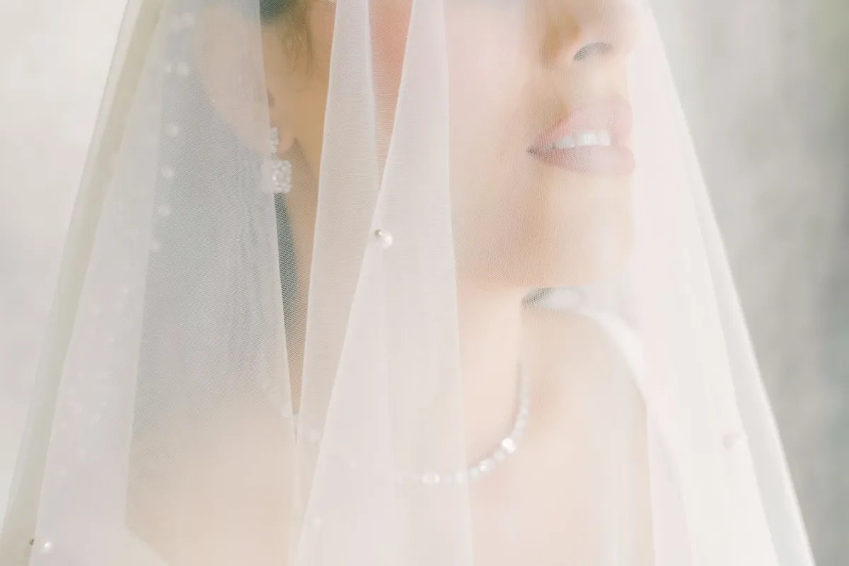 Bride with glowing skin under a soft veil